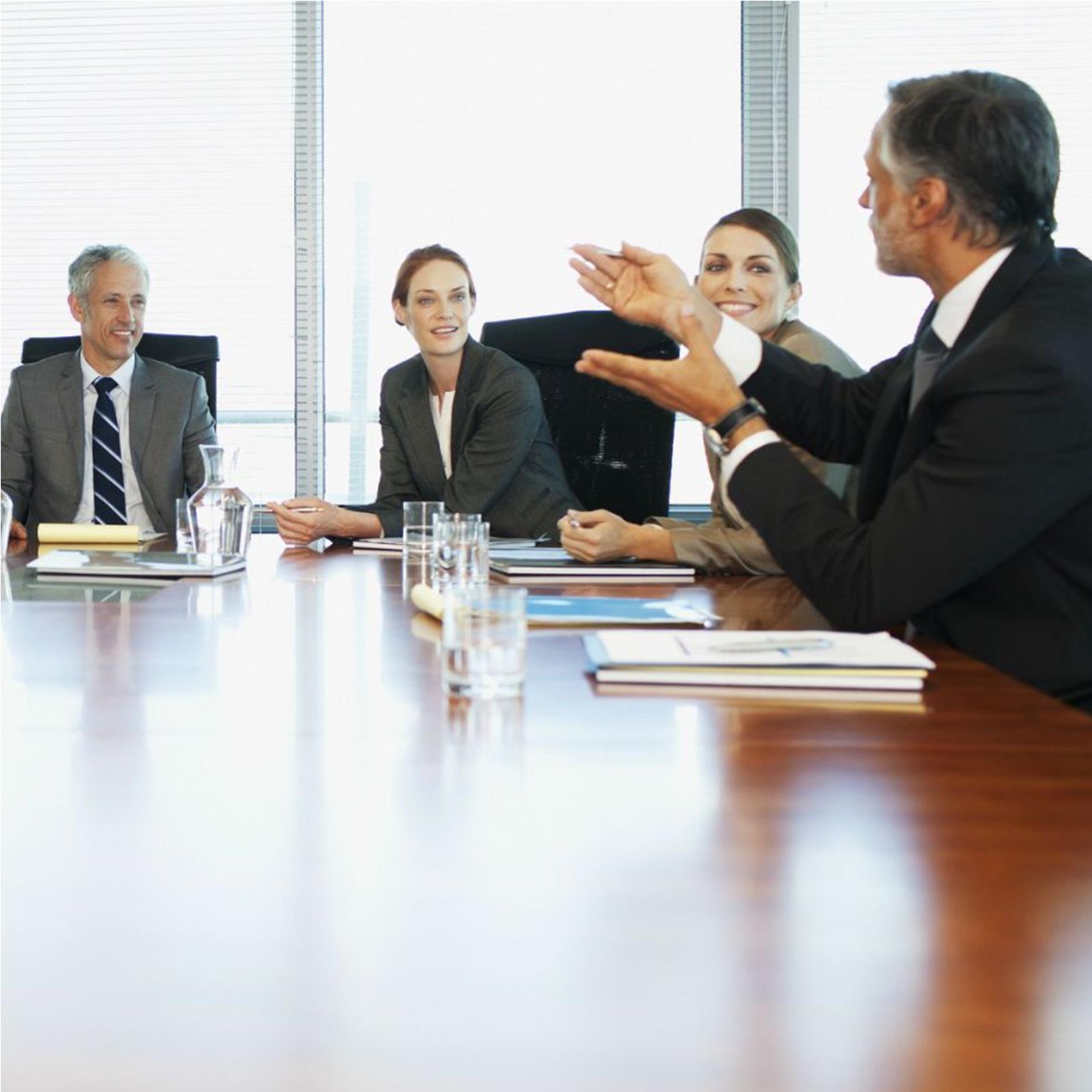 Board members sitting around board room table