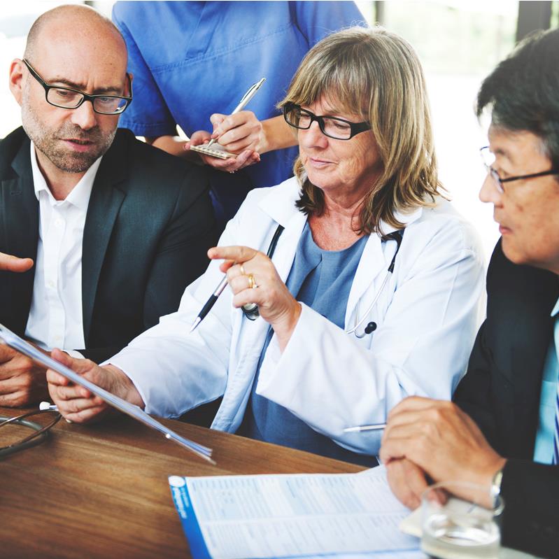 Executives and providers looking an at tablet